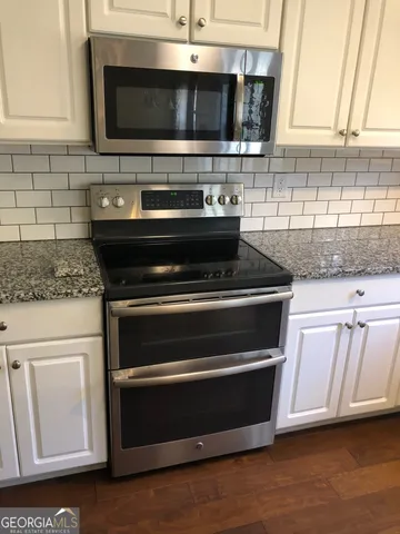 a kitchen with microwave cabinets and stainless steel appliances