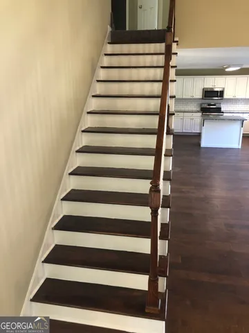 a view of entryway and hall with wooden floor