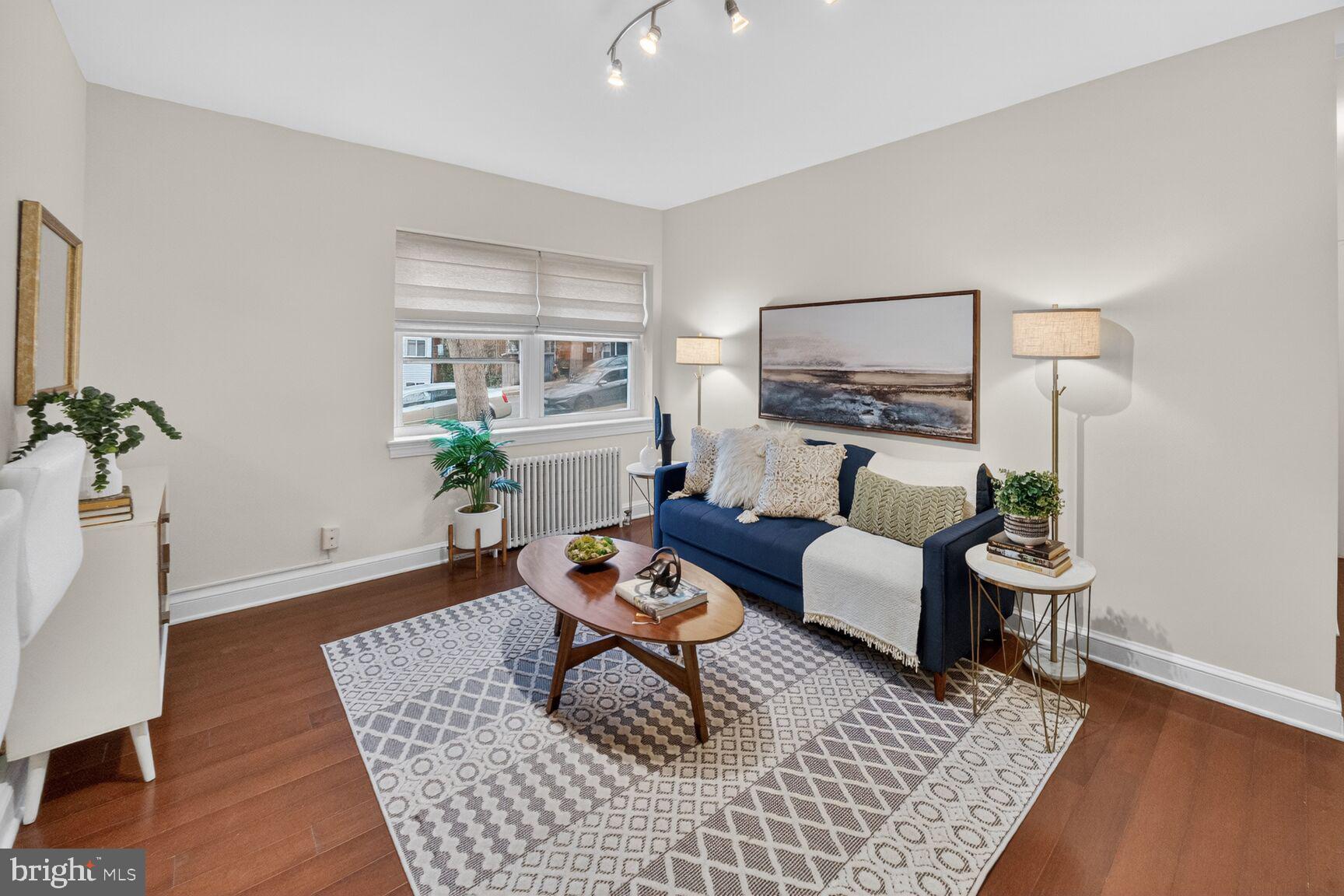 2339 40th Place Northwest, Unit 101 Washington, DC 20007 - Photo 3 of 12 a living room with furniture and wooden floor