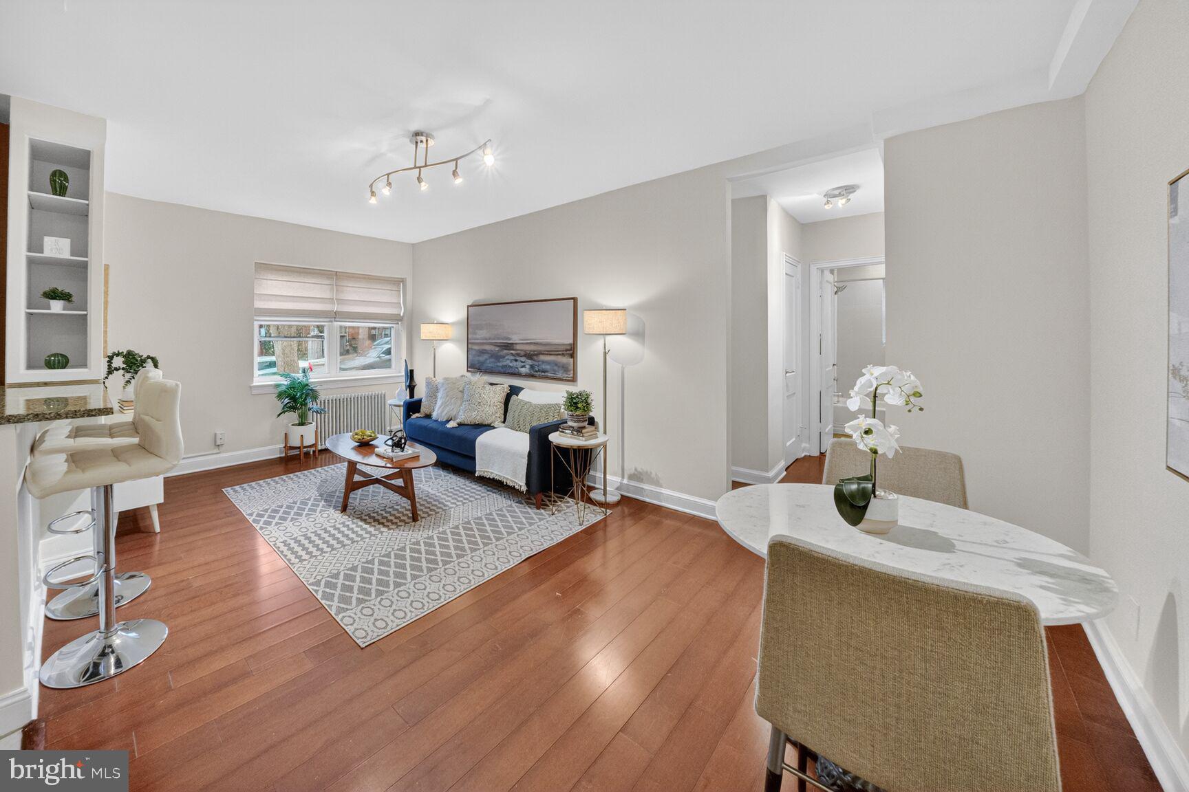 2339 40th Place Northwest, Unit 101 Washington, DC 20007 - Photo 5 of 12 a living room with furniture and a wooden floor