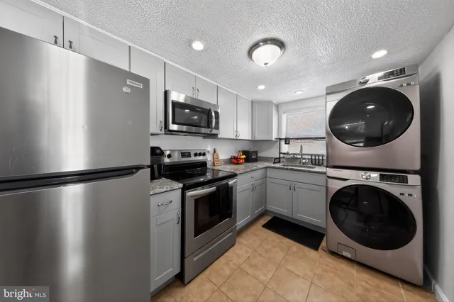 a kitchen with a refrigerator and a stove top oven