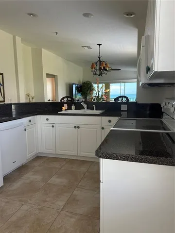 a kitchen with granite countertop a sink and cabinets