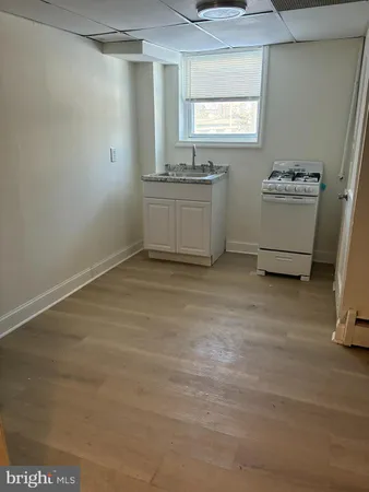 a room with a window and a dresser