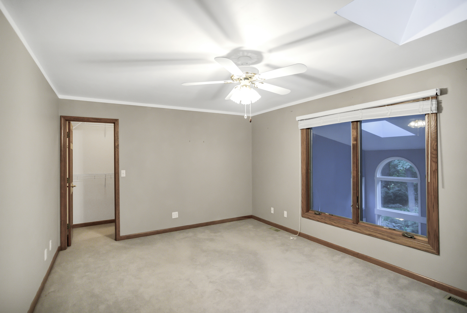 3 Hampton Court DeKalb, IL 60115 - Photo 21 of 35 an empty room with a ceiling fan and a window