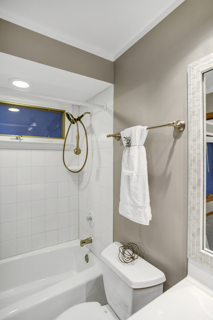3 Hampton Court DeKalb, IL 60115 - Photo 24 of 35 a bathroom with a bath tub sink and shower curtain