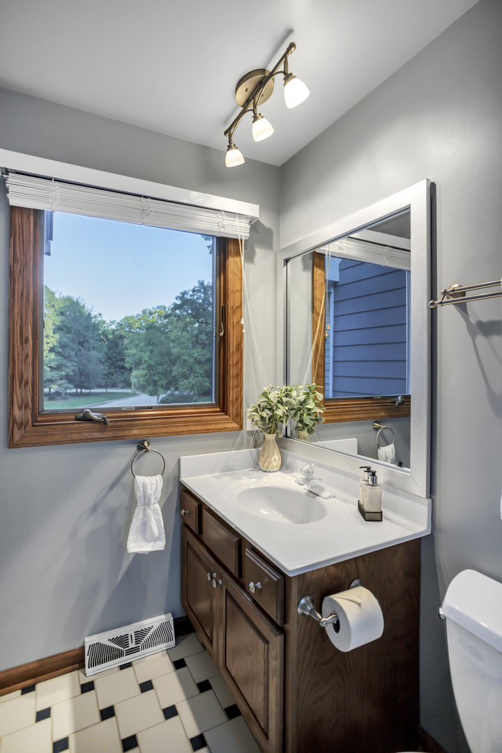3 Hampton Court DeKalb, IL 60115 - Photo 27 of 35 a bathroom with a sink a vanity and a mirror