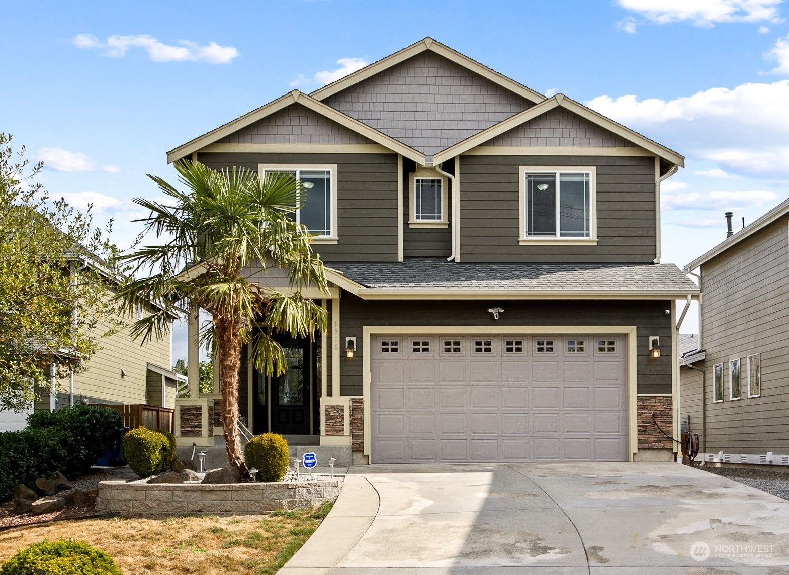 1910 Talbot Road South Renton, WA 98055 - Photo 1 of 26 a front view of a house with a yard and garage
