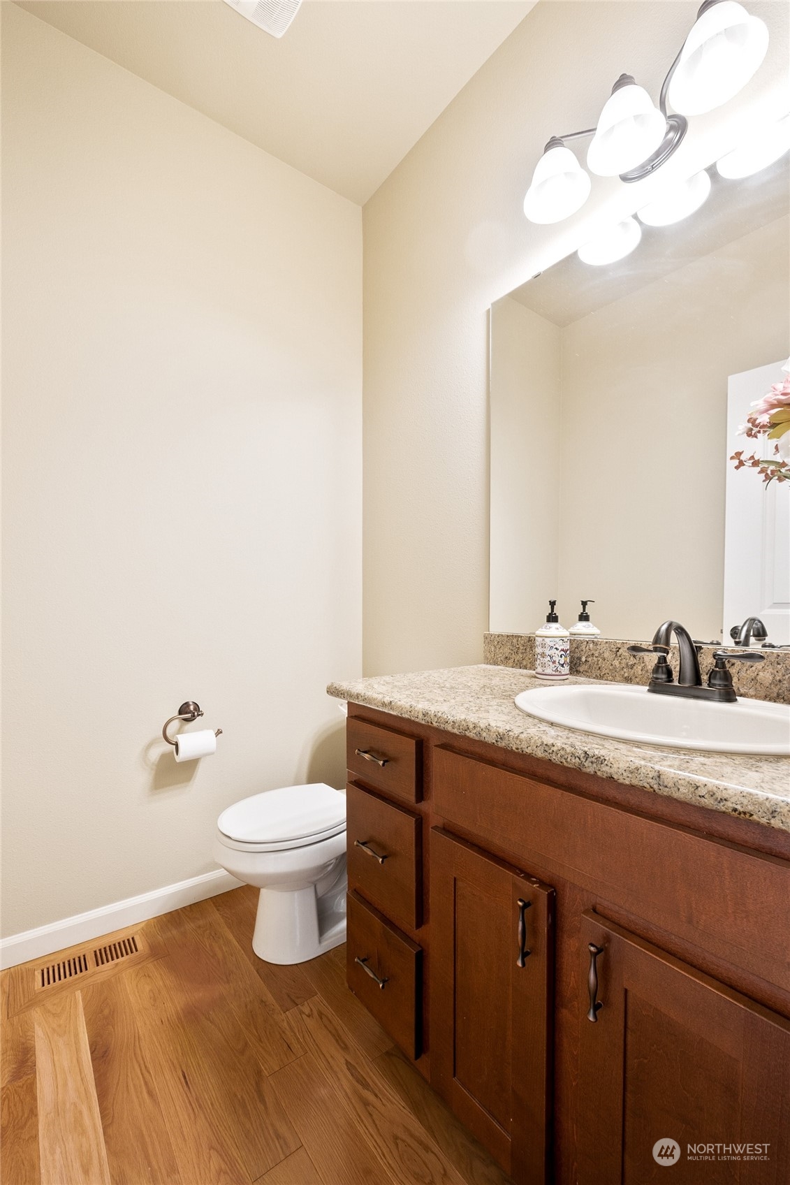 1910 Talbot Road South Renton, WA 98055 - Photo 13 of 26 a bathroom with a granite countertop sink a toilet and a mirror