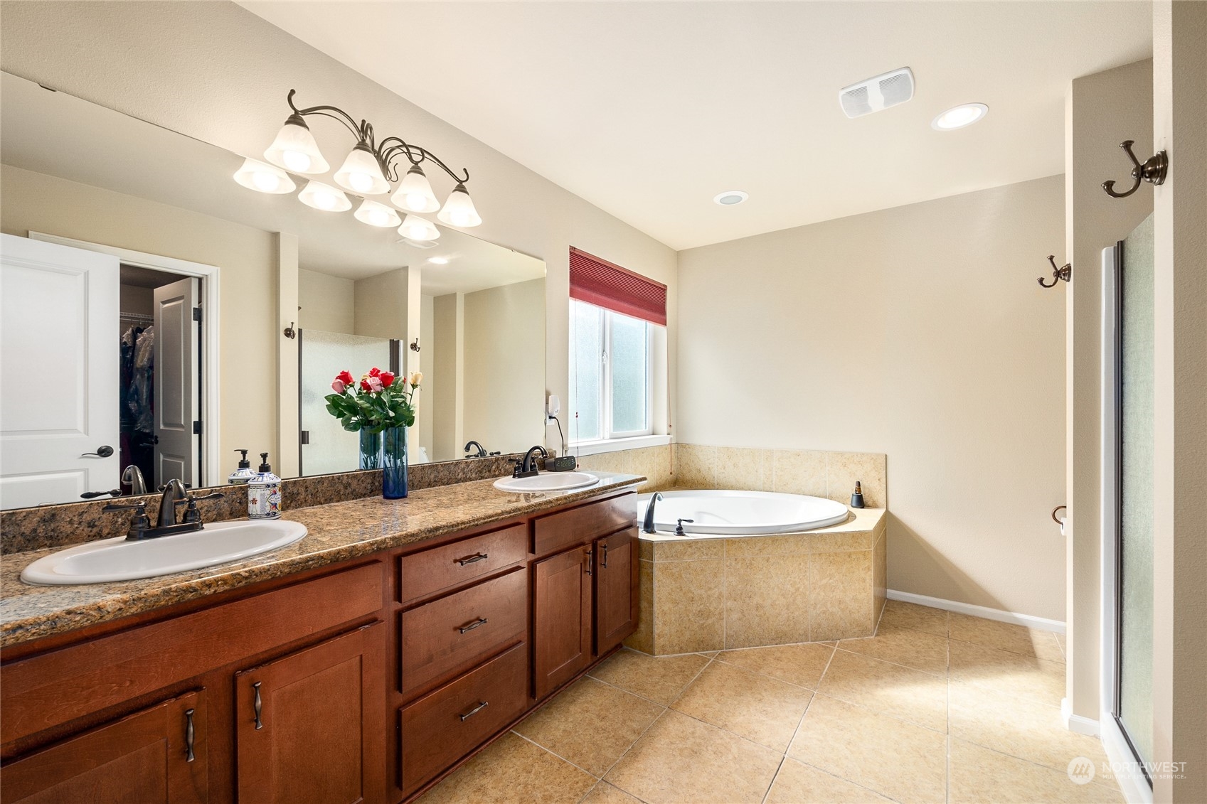 1910 Talbot Road South Renton, WA 98055 - Photo 17 of 26 a spacious bathroom with a bathtub sink mirror and double vanity