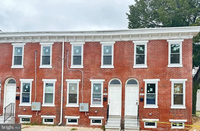 a front view of a building with a lot of windows