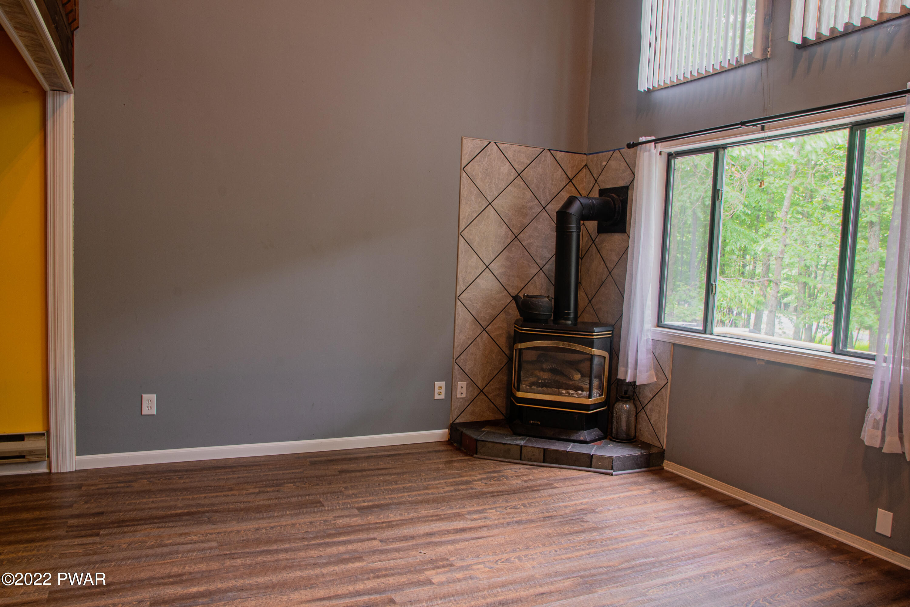 375 Mallard Lane Bushkill, PA 18324 - Photo 6 of 28 a view of an empty room with wooden floor and a window