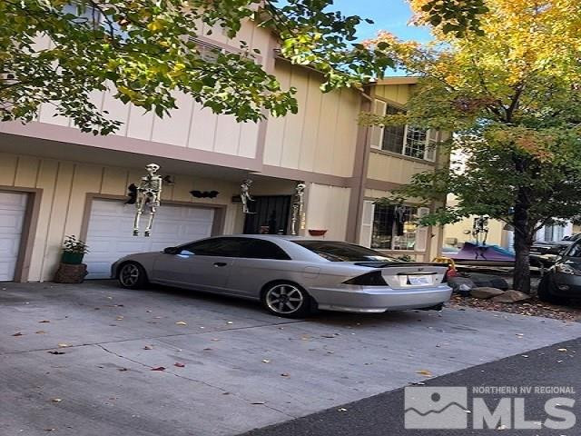 1308 Powell Lane Reno, NV 89502 - Photo 2 of 2 a car parked in front of a white house