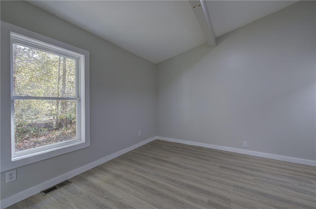 76 Morning Dew Lane Clayton, GA 30525 - Photo 13 of 28 an empty room with wooden floor and windows