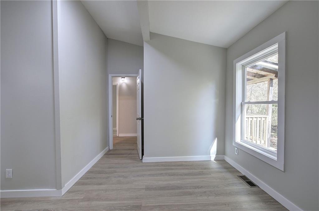 76 Morning Dew Lane Clayton, GA 30525 - Photo 15 of 28 an empty room with wooden floor and windows