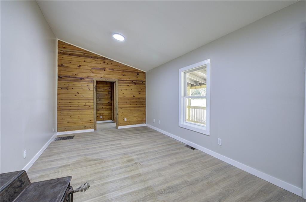 76 Morning Dew Lane Clayton, GA 30525 - Photo 19 of 28 an empty room with wooden floor and windows