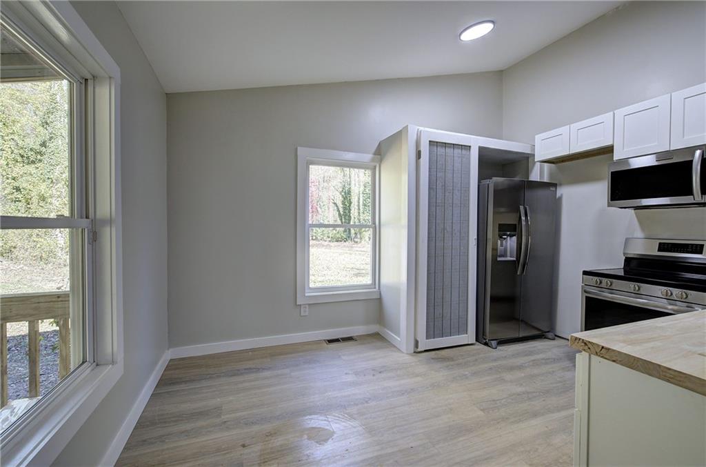76 Morning Dew Lane Clayton, GA 30525 - Photo 21 of 28 a view of kitchen with wooden floor electronic appliances and window