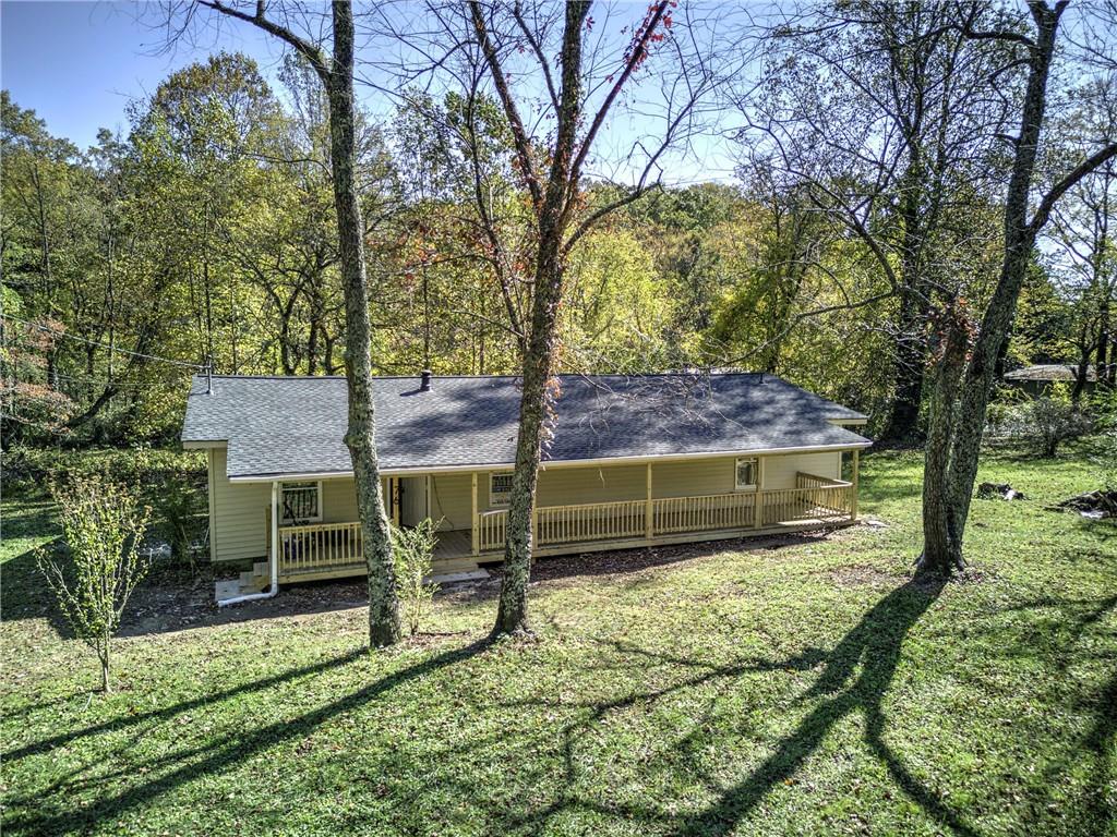 76 Morning Dew Lane Clayton, GA 30525 - Photo 23 of 28 a view of a backyard with wooden fence and a large tree