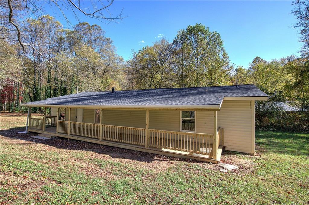 76 Morning Dew Lane Clayton, GA 30525 - Photo 26 of 28 a view of a house with a backyard and wooden fence