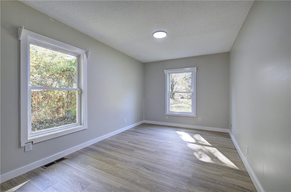 76 Morning Dew Lane Clayton, GA 30525 - Photo 4 of 28 a view of an empty room with wooden floor and a window