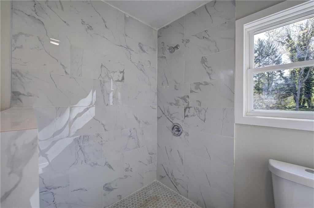 76 Morning Dew Lane Clayton, GA 30525 - Photo 6 of 28 a bathroom with a shower