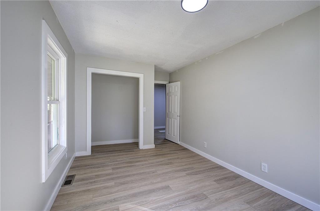 76 Morning Dew Lane Clayton, GA 30525 - Photo 8 of 28 a view of an empty room with wooden floor