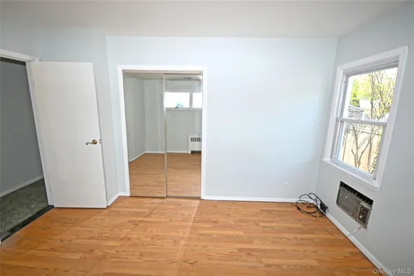 an empty room with windows and closet
