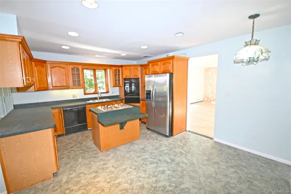 a kitchen with stainless steel appliances granite countertop a refrigerator and a sink