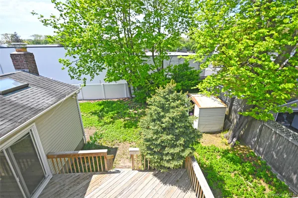 a view of a backyard with sitting area