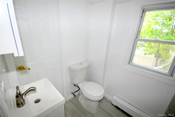 a white toilet sitting next to a bathroom sink
