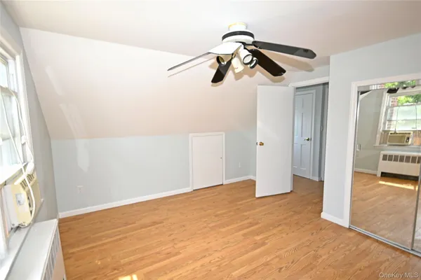 a view of a room with a wooden floor and windows