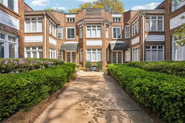 a view of a brick building next to a big yard