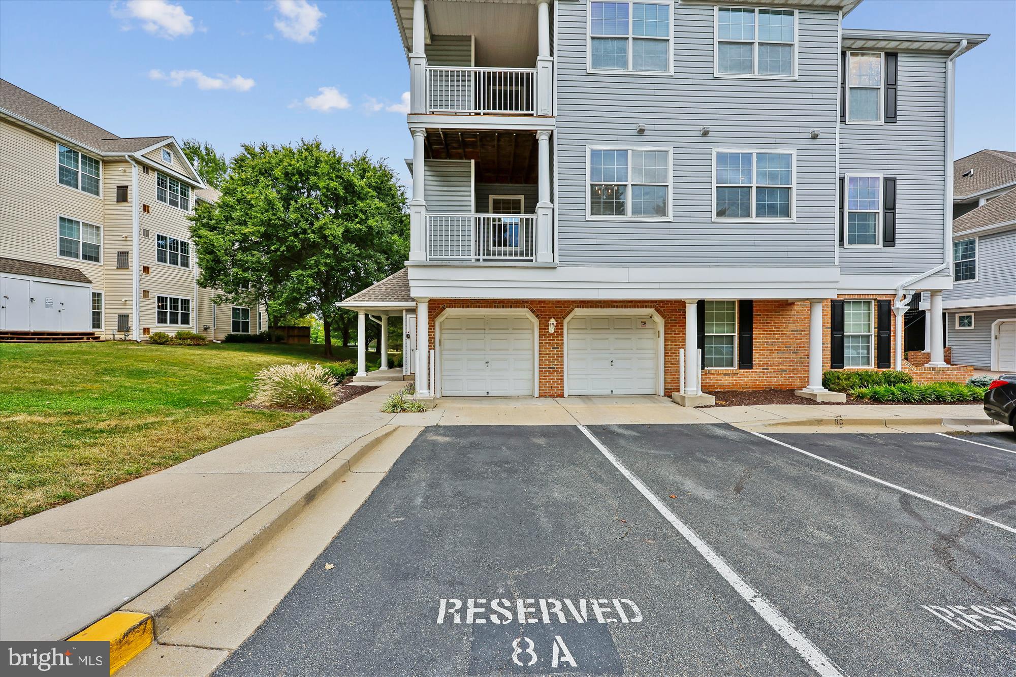 12701 Found Stone Road, Unit 201 Germantown, MD 20876 - Photo 12 of 41 a front view of a residential apartment building with a yard