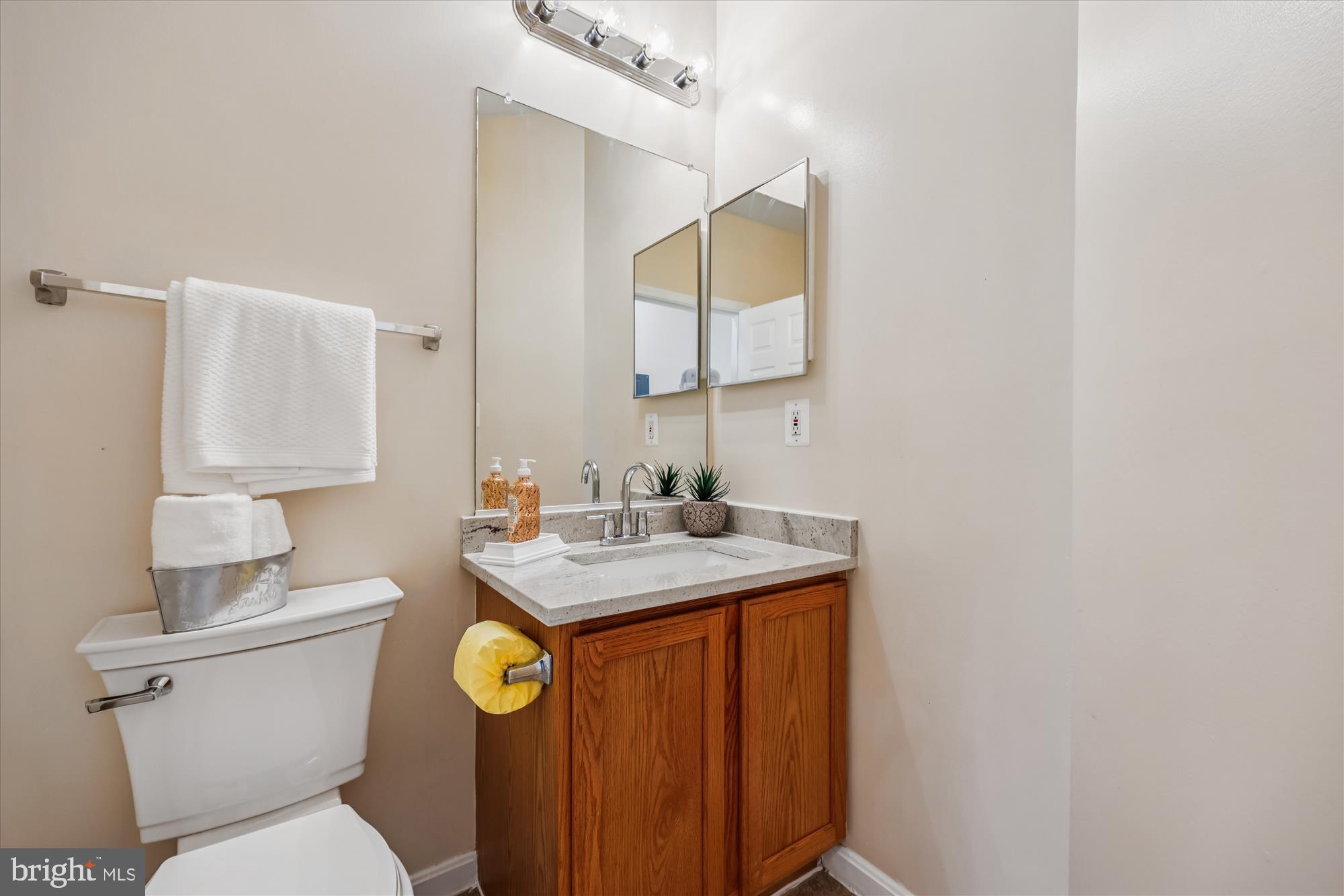 12701 Found Stone Road, Unit 201 Germantown, MD 20876 - Photo 13 of 41 a bathroom with a toilet a sink and mirror