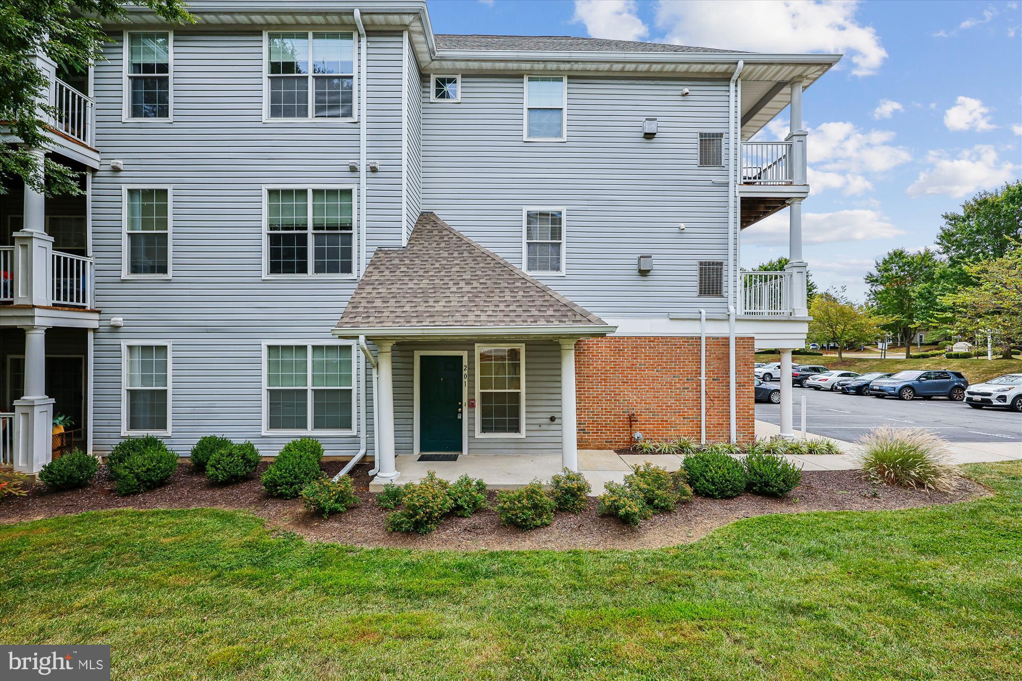 12701 Found Stone Road, Unit 201 Germantown, MD 20876 - Photo 18 of 41 a front view of a house with a yard and garage