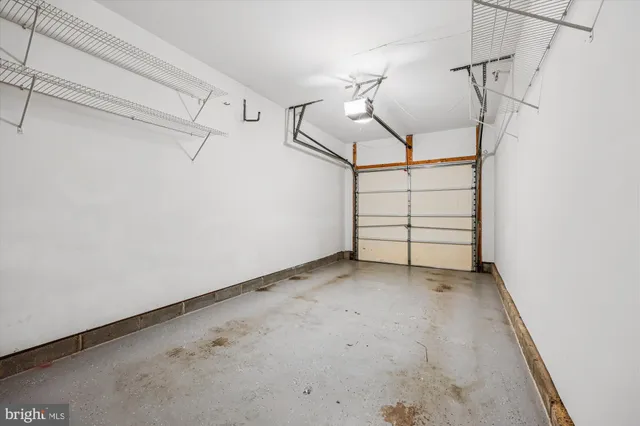 a kitchen with sink a refrigerator and a view of living room