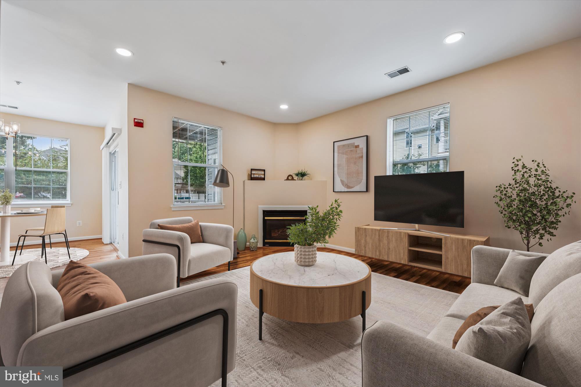 12701 Found Stone Road, Unit 201 Germantown, MD 20876 - Photo 2 of 41 a living room with furniture and a flat screen tv