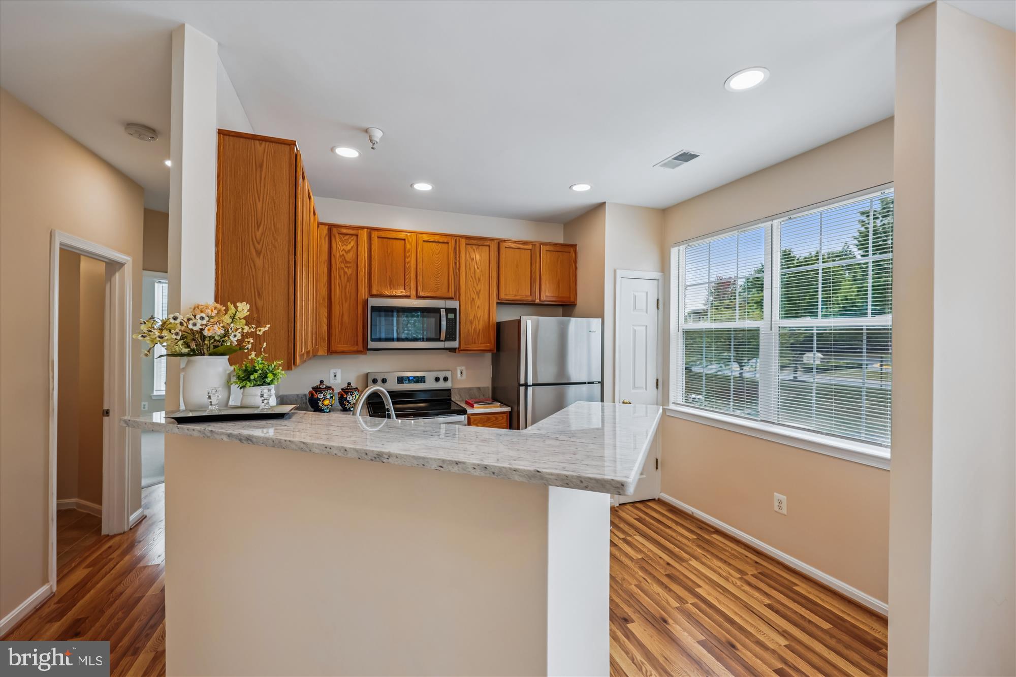12701 Found Stone Road, Unit 201 Germantown, MD 20876 - Photo 21 of 41 a kitchen with sink a refrigerator and a view of living room