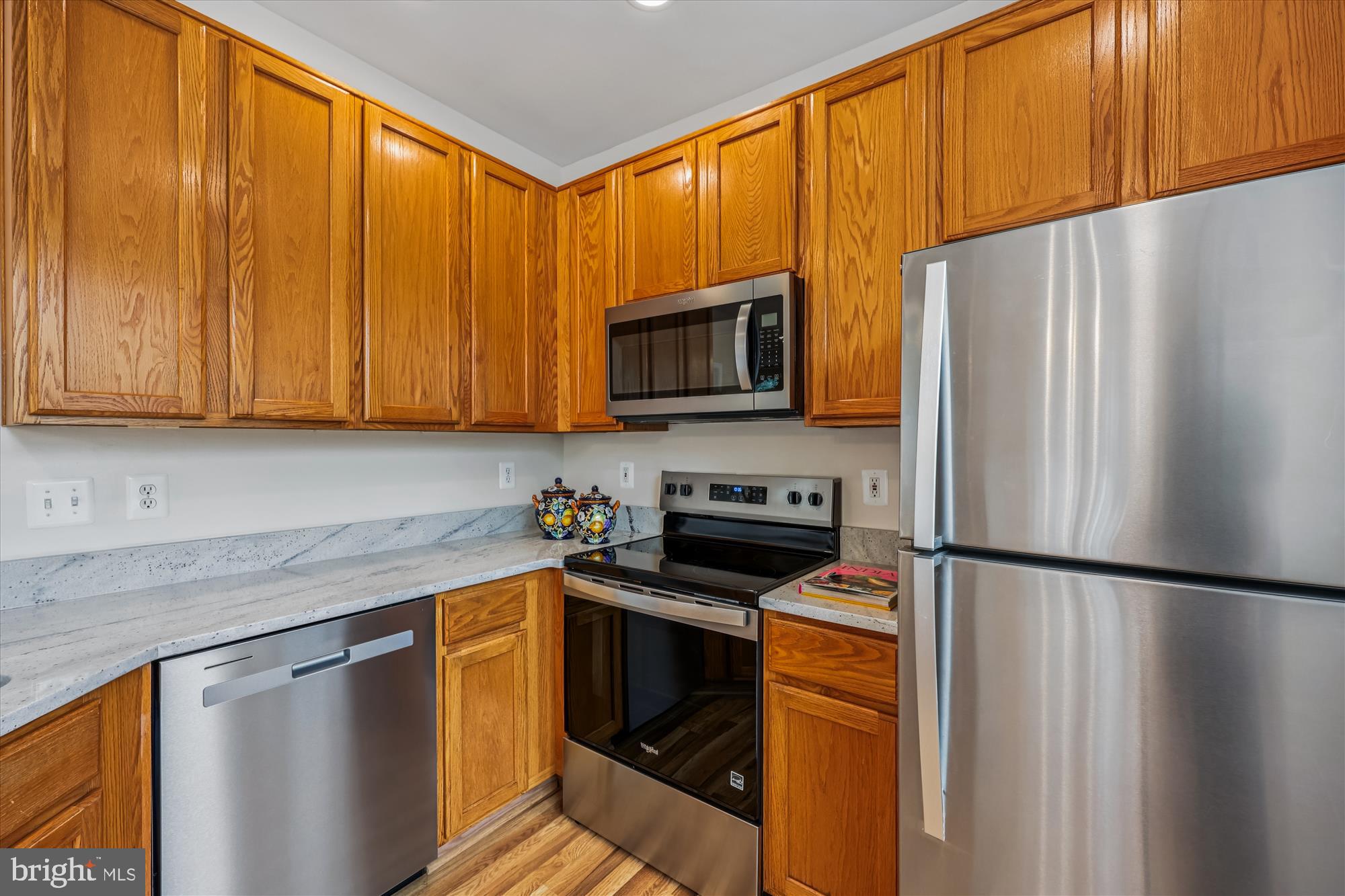 12701 Found Stone Road, Unit 201 Germantown, MD 20876 - Photo 3 of 41 a kitchen with stainless steel appliances a refrigerator sink and microwave