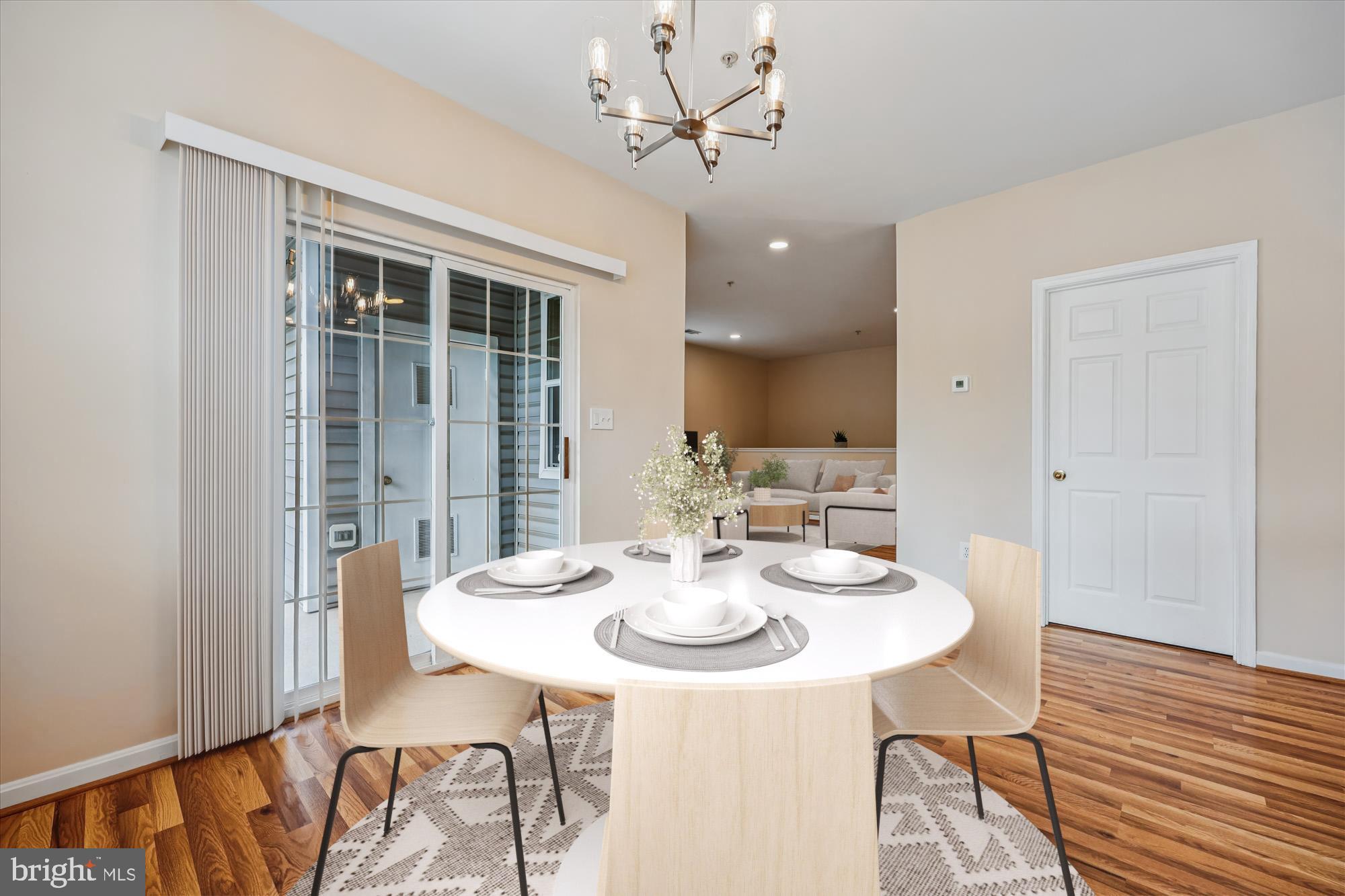 12701 Found Stone Road, Unit 201 Germantown, MD 20876 - Photo 4 of 41 a view of a dining room with furniture window and wooden floor