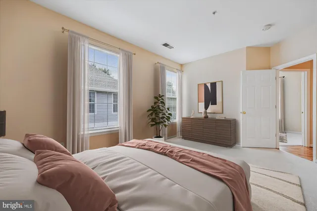 a bedroom with a large bed and a window