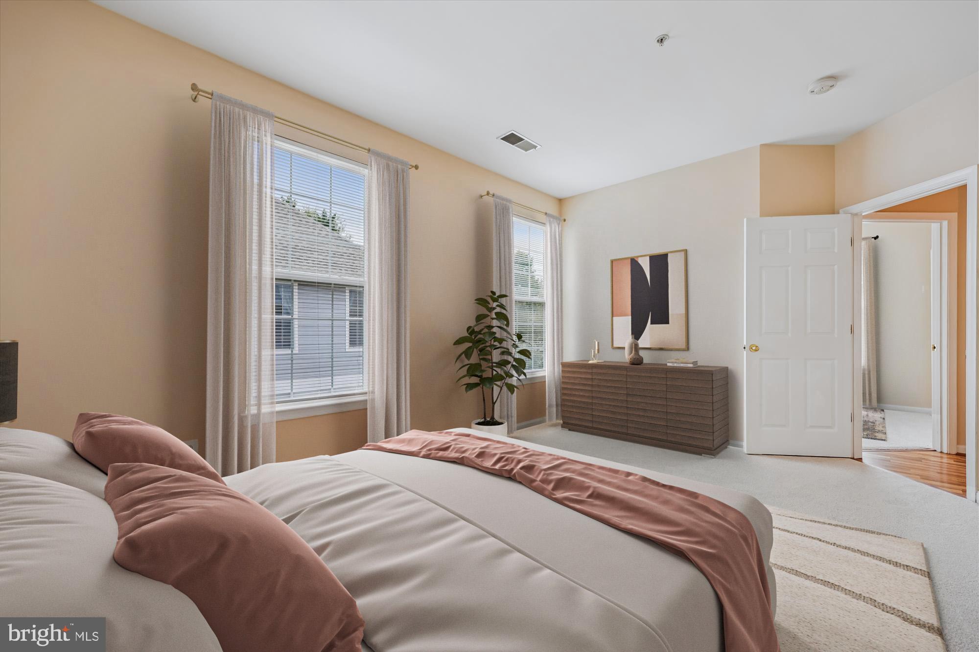 12701 Found Stone Road, Unit 201 Germantown, MD 20876 - Photo 5 of 41 a bedroom with a large bed and dresser