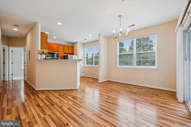 a open kitchen with stainless steel appliances granite countertop a refrigerator and a stove top oven
