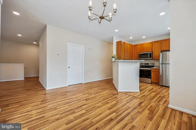 a view of a room with wooden floor and ceiling fan