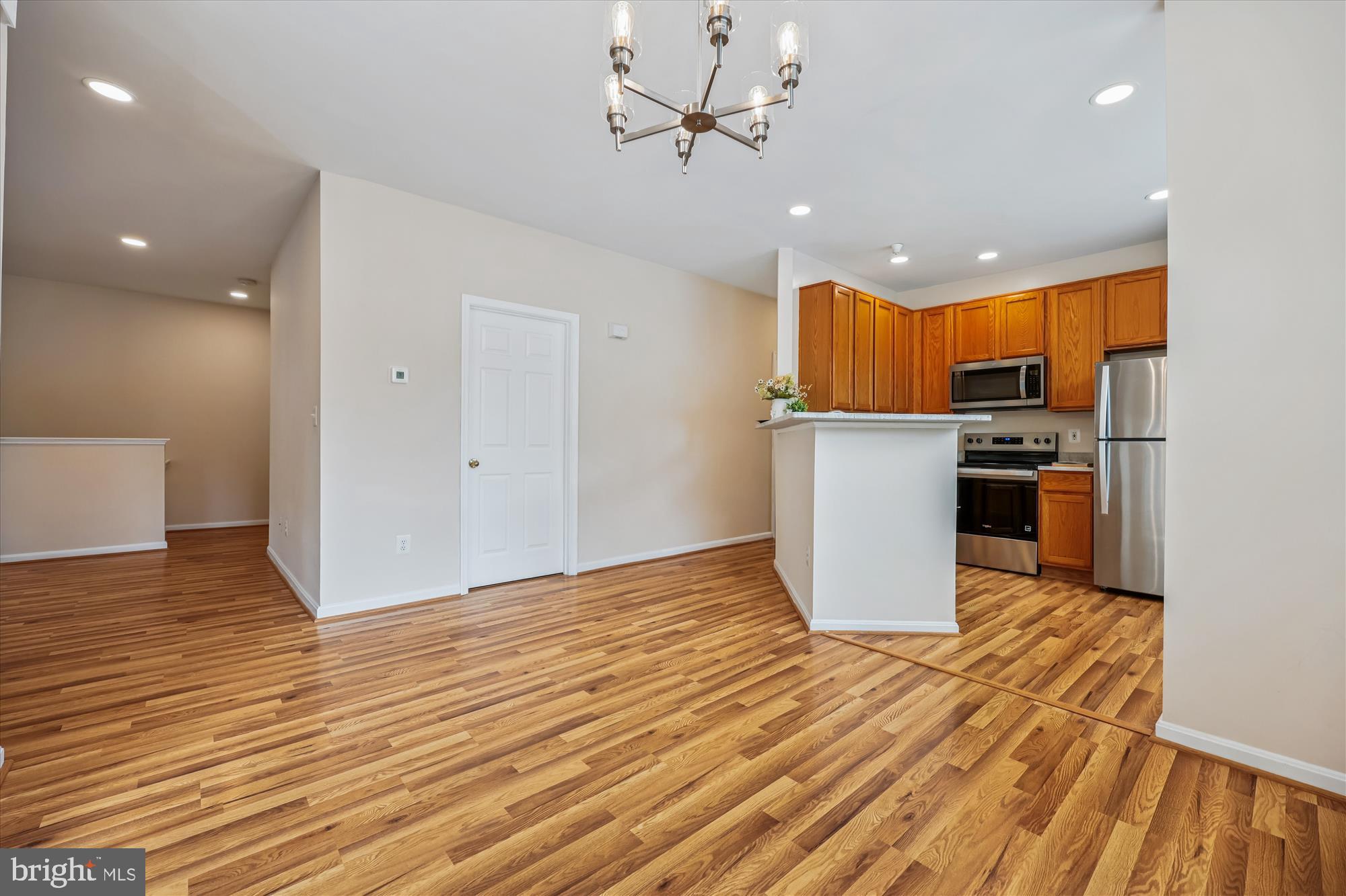 12701 Found Stone Road, Unit 201 Germantown, MD 20876 - Photo 10 of 41 a open kitchen with stainless steel appliances granite countertop a refrigerator and a stove top oven