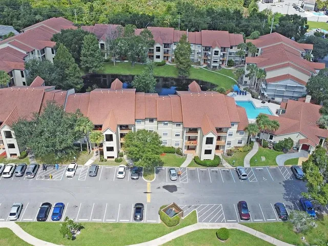 an aerial view of residential houses with outdoor space and street view