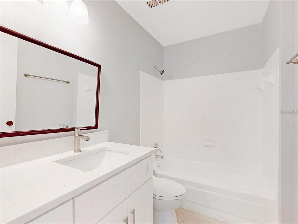 3032 Parkway Boulevard, Unit 108 Kissimmee, FL 34747 - Photo 5 of 7 a bathroom with a sink and a mirror