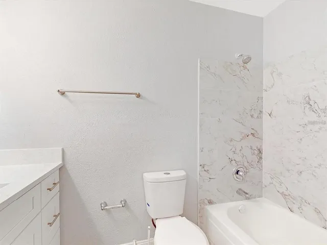 a bathroom with a toilet and a bathtub