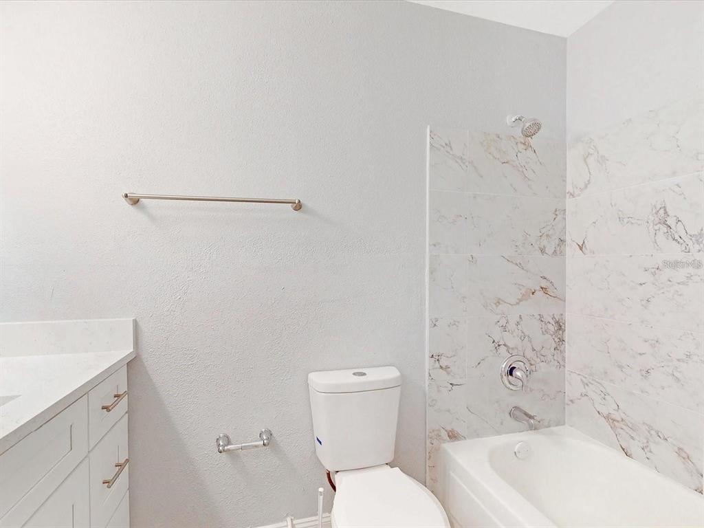 3032 Parkway Boulevard, Unit 108 Kissimmee, FL 34747 - Photo 7 of 7 a bathroom with a toilet and a bathtub