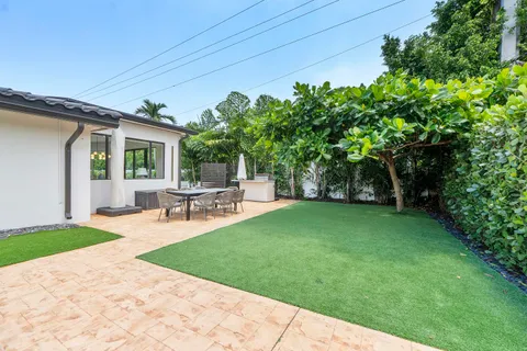 a view of a backyard with sitting area furniture and garden