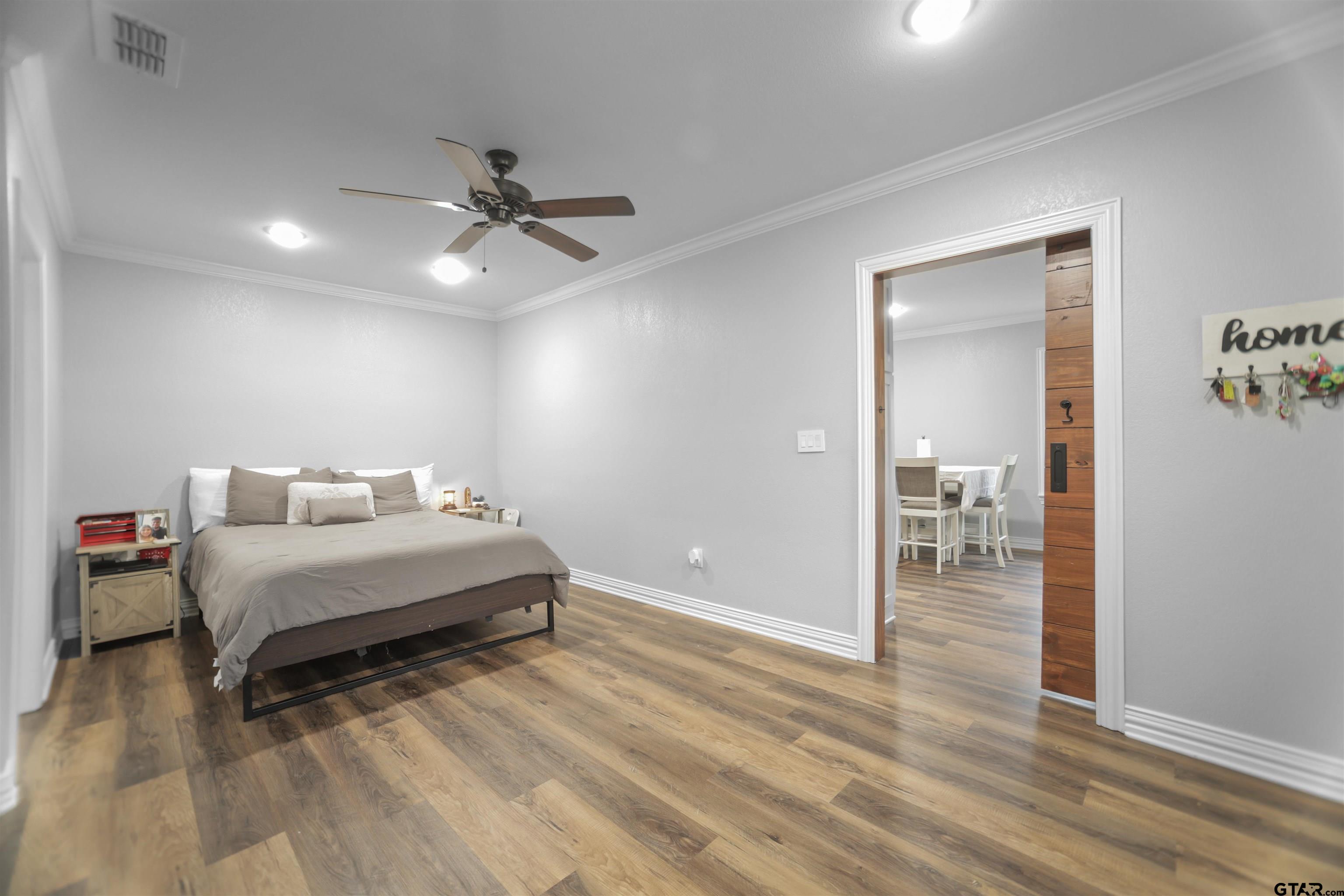 11931 State Highway 64 Tyler, TX 75704 - Photo 35 of 44 a spacious bedroom with a bed and ceiling fan